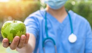 Hand holding an apple